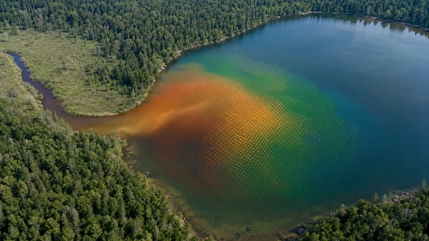 Satellite-style lake image showing a tea-colored dissolved organic matter plume from a wetland inlet