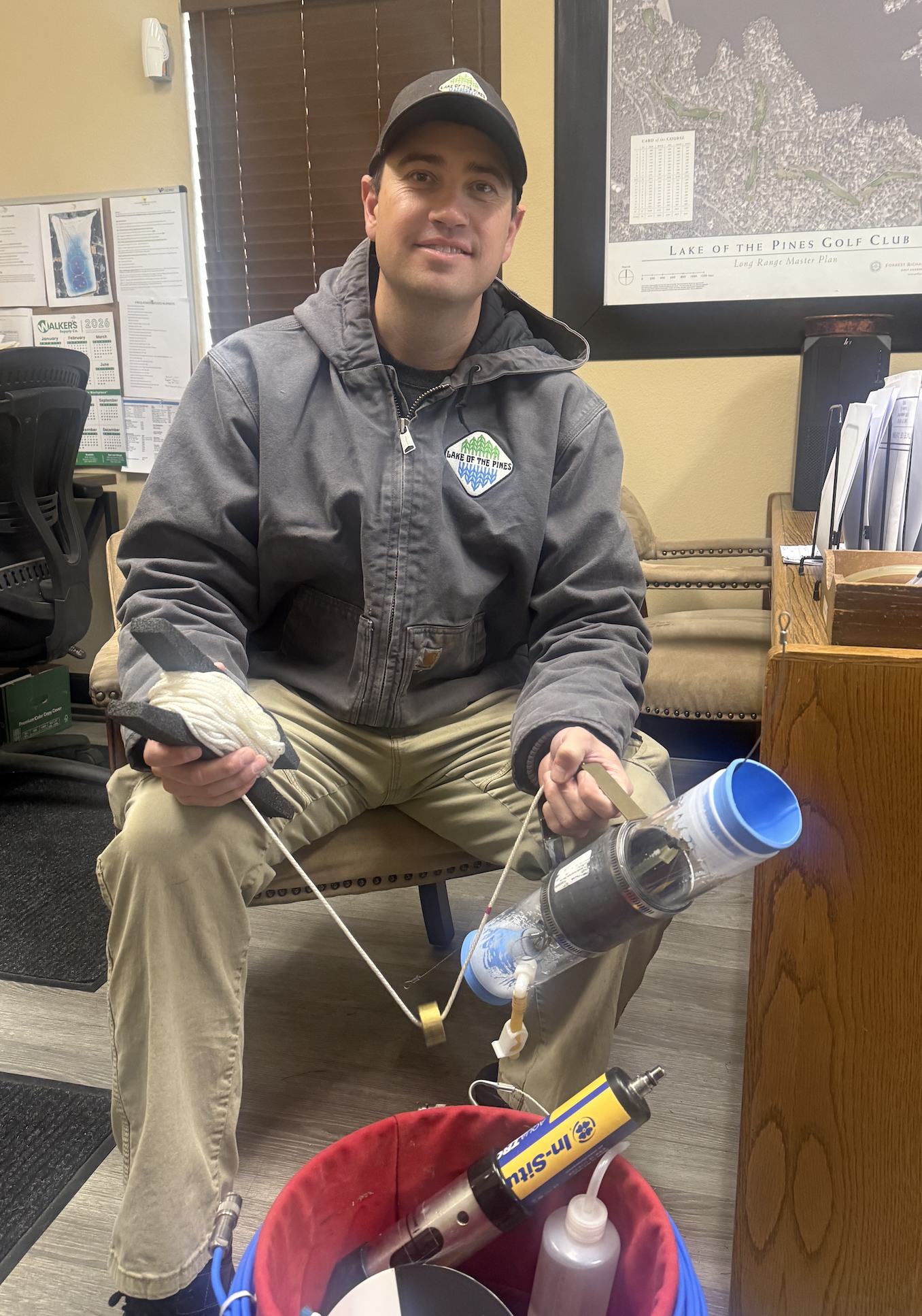 Lake of the Pines staff member with water quality sampling equipment